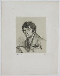 [Young man sitting in armchair]